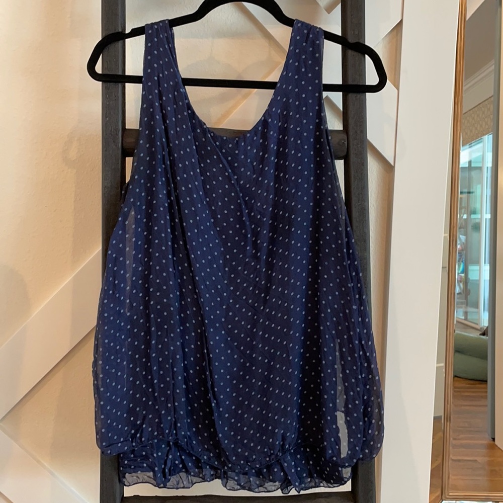 Flowing polka a dot tank top with ruffle bottom.